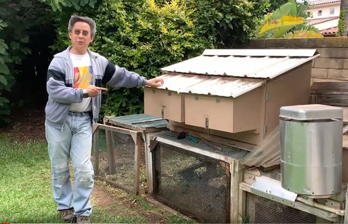 Photo of the creator of the Wall-E Robot, Mike Senna demonstrates his version of the automated chicken coop