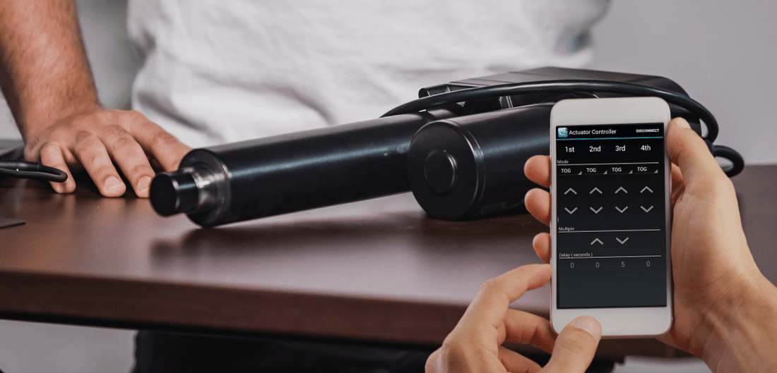 Photo of arm man has a mobile telephone on which image of  Wi-Fi Actuator App and linear actuator on white background