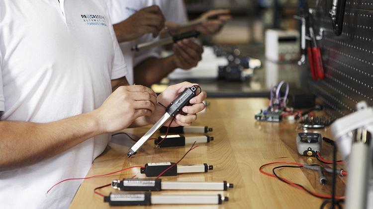 Photo of a man testing a linear actuator