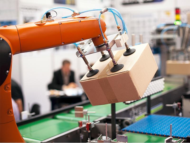Photo of a Robotic Gripper holding a box 